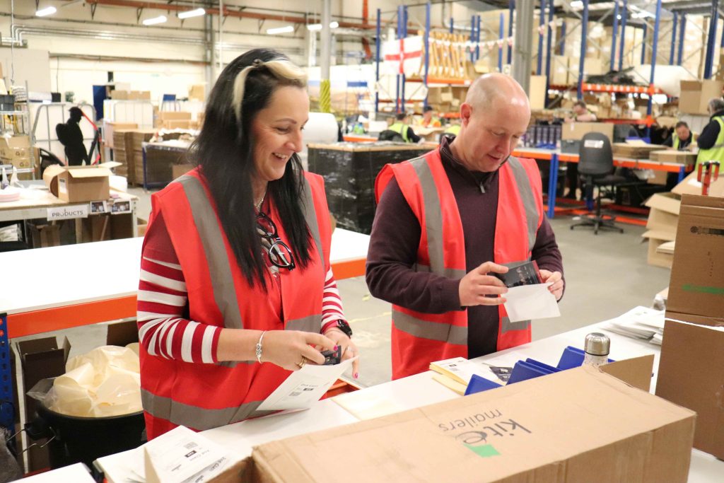 Two volunteers from Vinci working with our fulfilment team