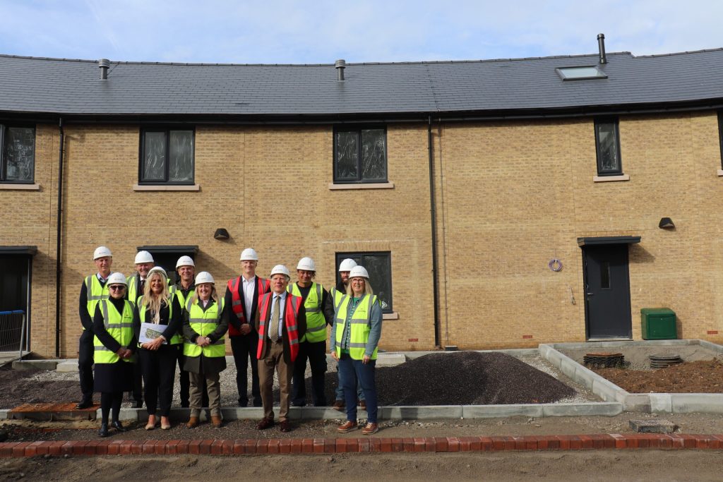 Group photo outside the centenary village development