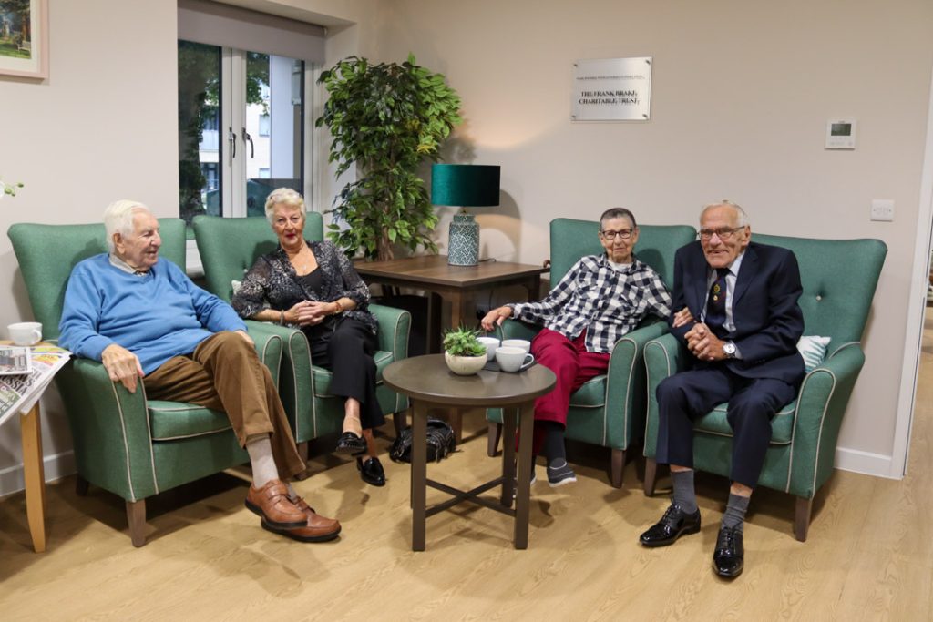 Group of care home residents chatting in the evening