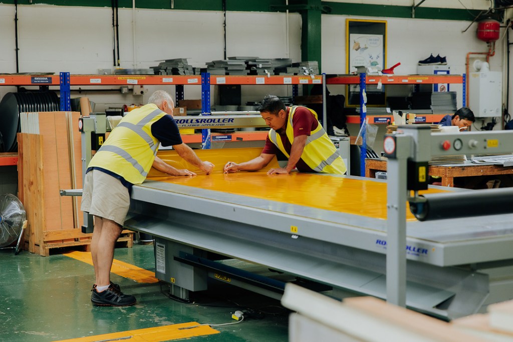 BBMC employees using signage machinery