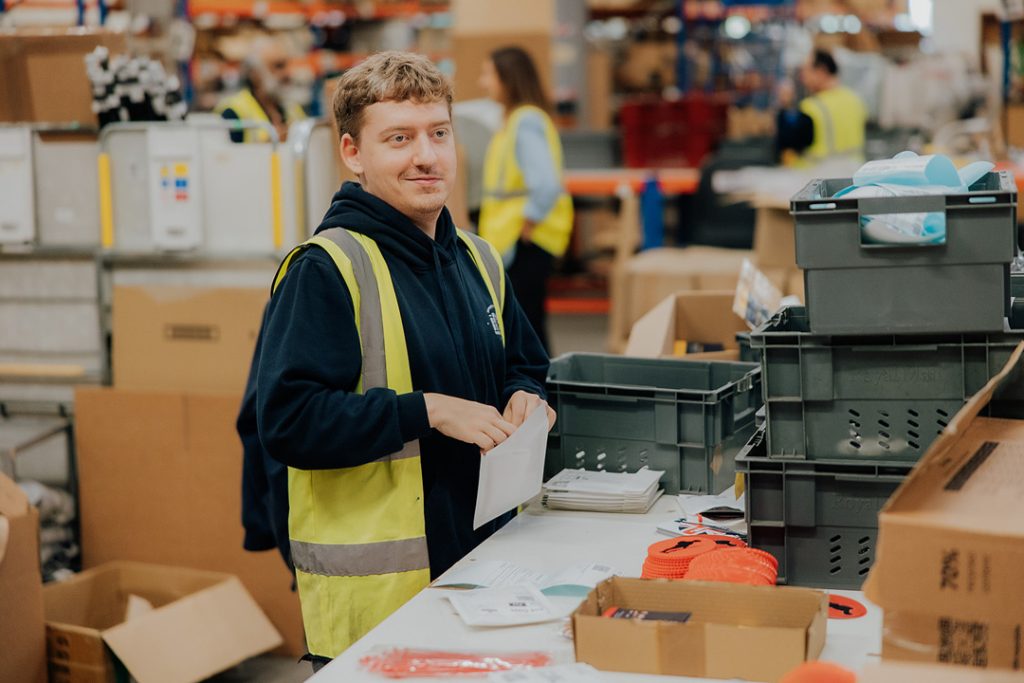 Social Enterprise employee George packing orders for delivery