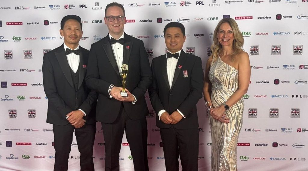 Four RBVE employees posing with Soldiering On Award on the red carpet